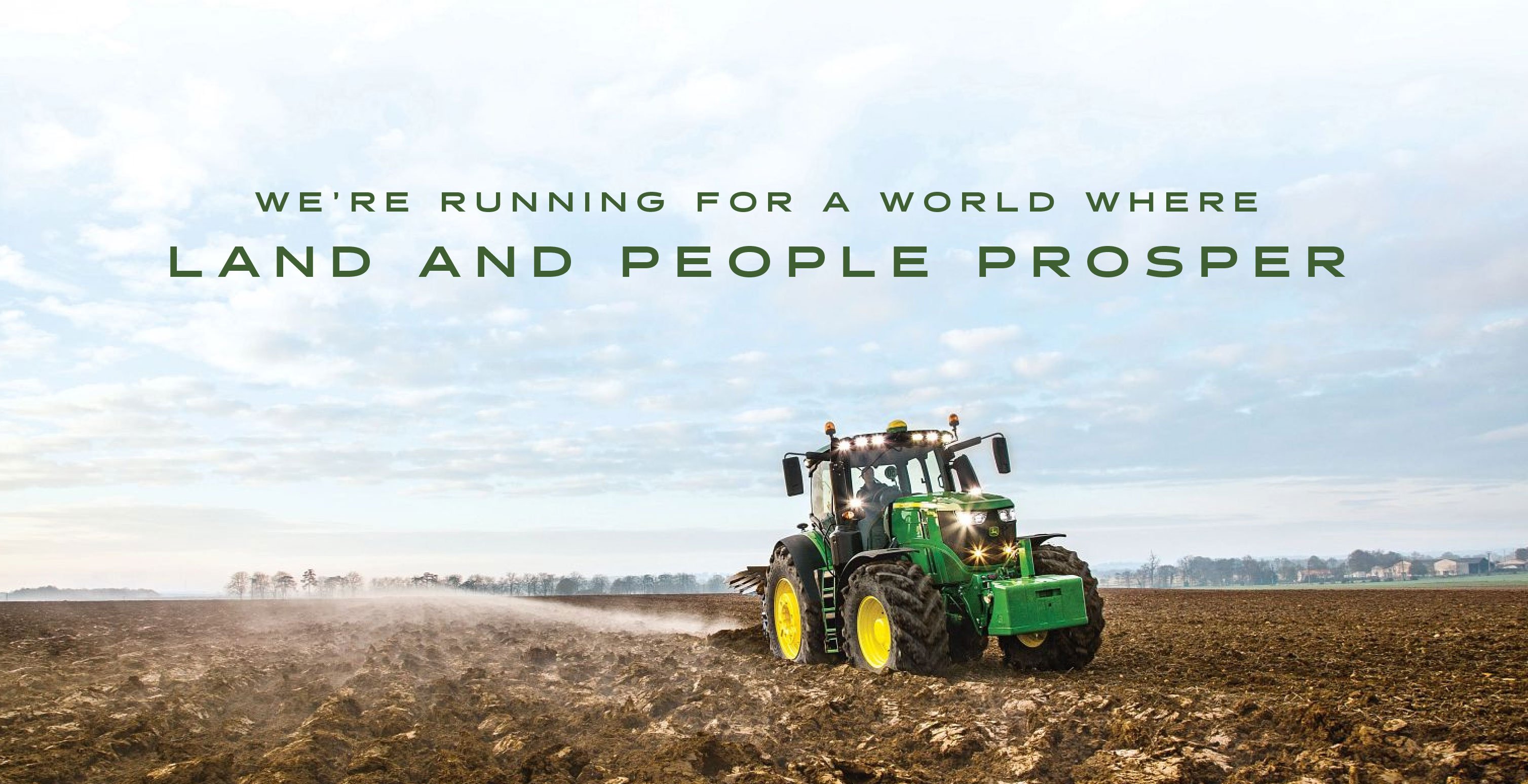 john deere tractor plowing field with text that says we're running for a wold where land and people prosper
